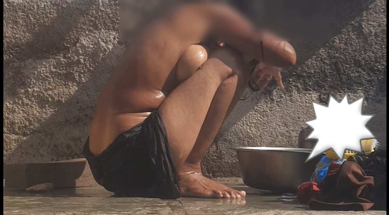 The stepsister is bathing naked in an open bathroom in the village