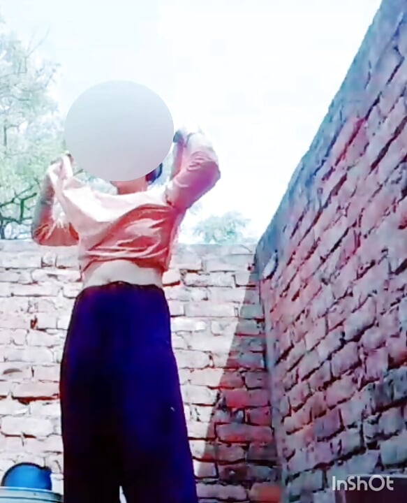 A very beautiful girl was taking bath in her courtyard