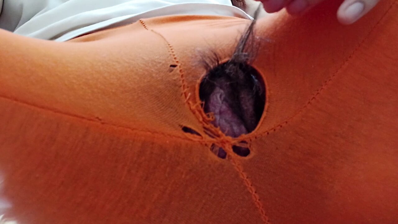 Indian girl working from home with hole in her pants. Under table view.